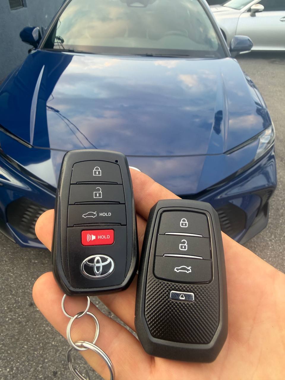Two programmed Toyota car keys in front of the vehicle